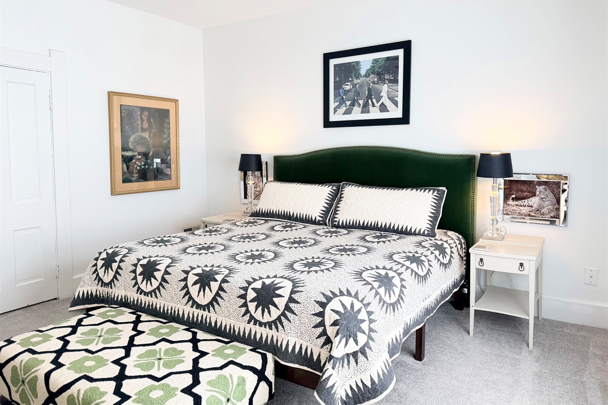 Spacious king bedroom with ceiling fan and evening-ready details with soft bedside lighting & layered textures — quiet, calming, and thoughtfully styled.

