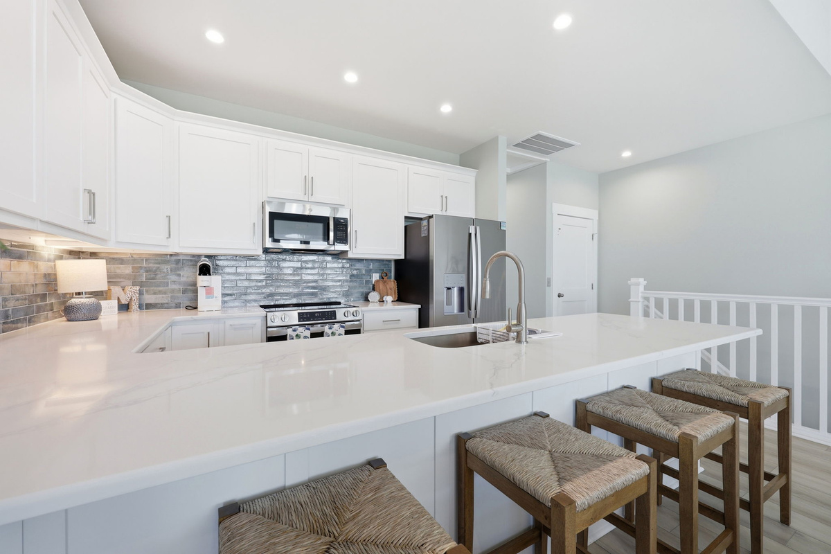 The oversized island offers plenty of prep space and casual seating for morning coffee or evening snacks