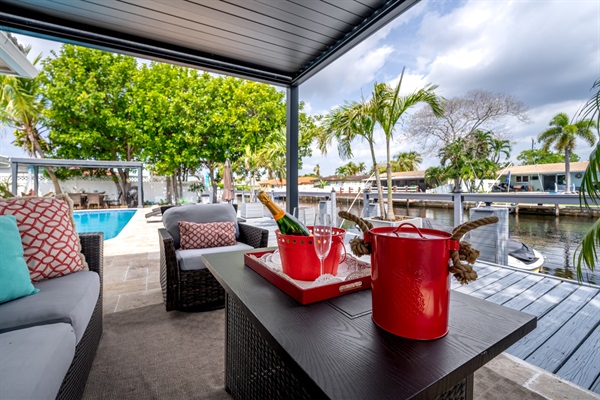 Relaxing waterfront backyard with pool and sun loungers