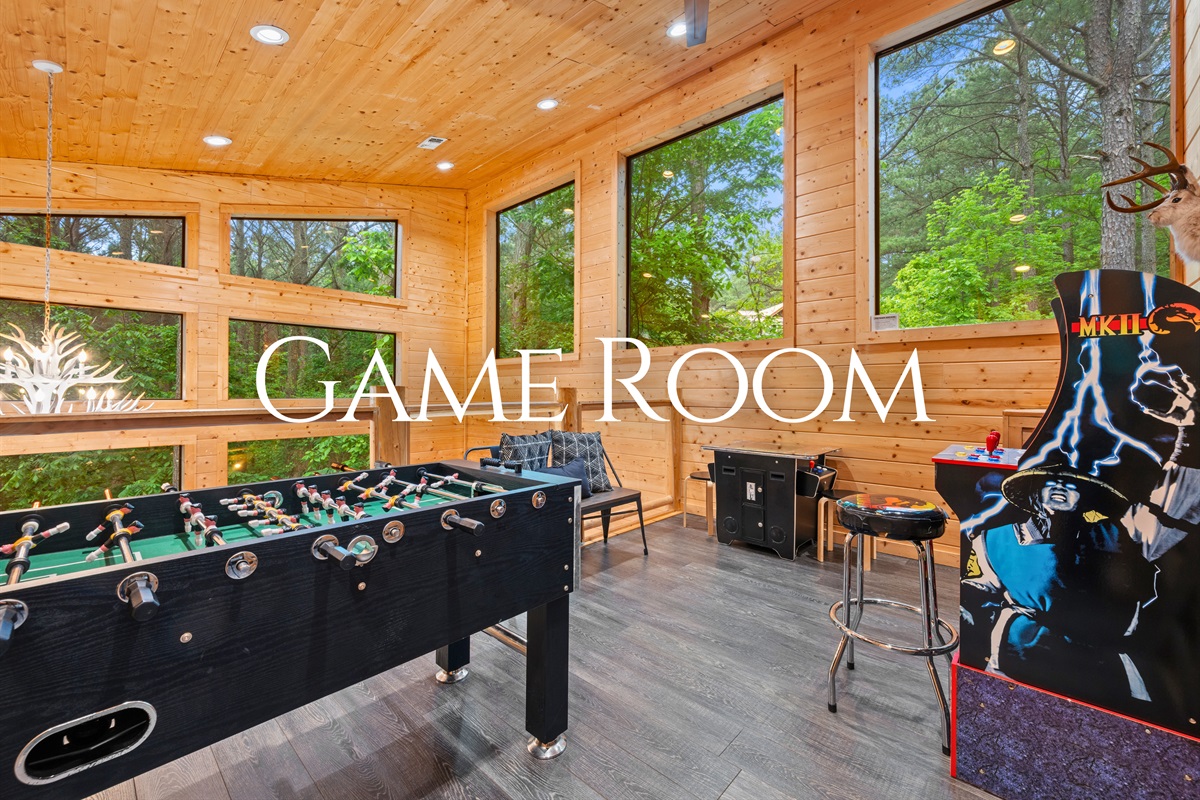 The game room is ready for fun, with a foosball table and plenty of space to gather and enjoy some friendly competition.