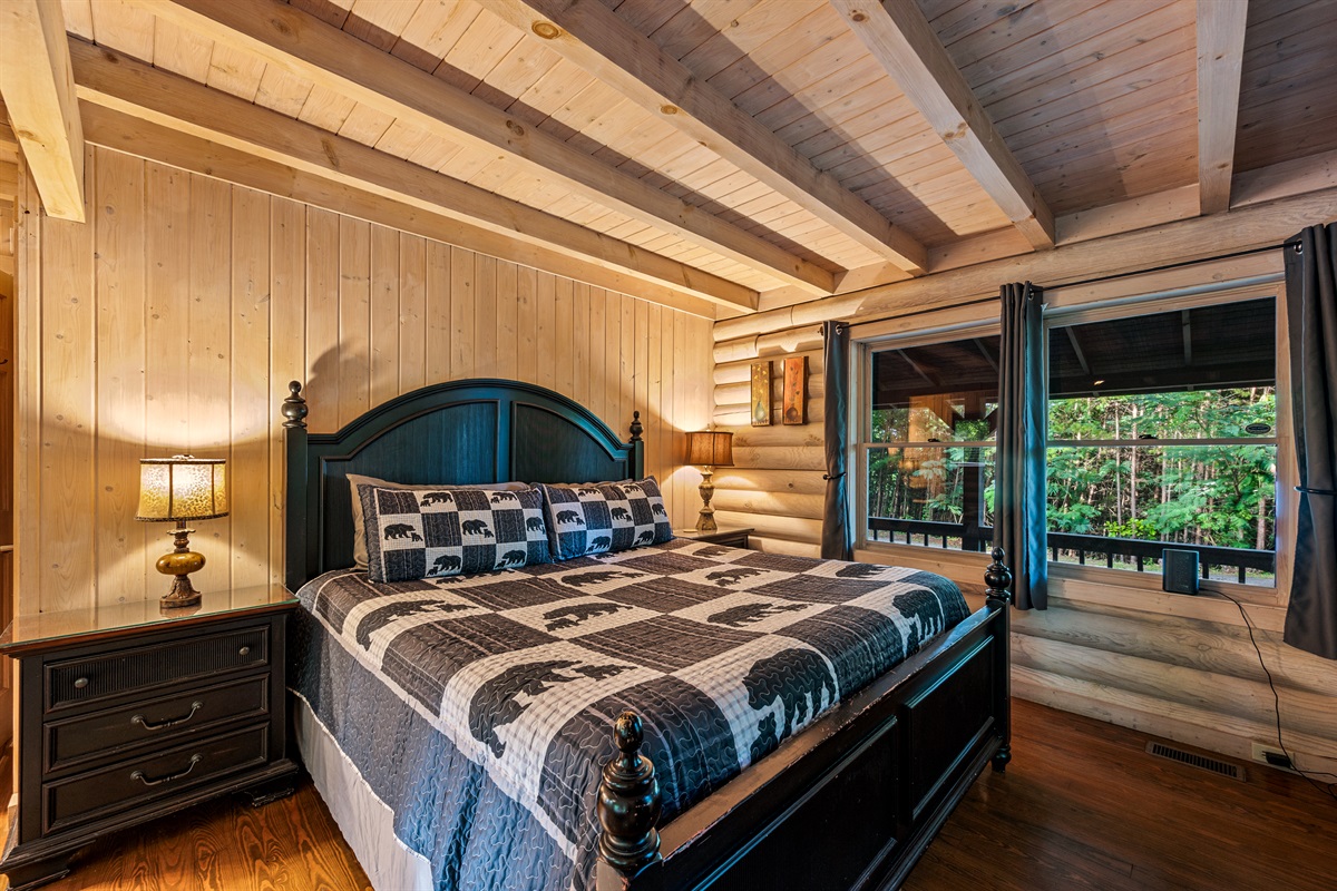 Your private king suite awaits with cozy cabin vibes and serene forest views.
