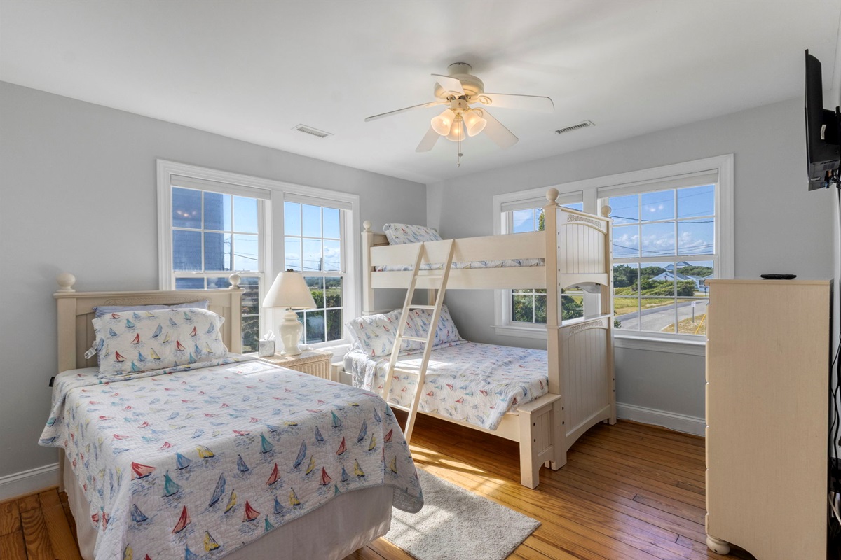 The bunk bedroom holds a standalone twin bed and a twin over full bunk bed. A shared Jack and Jill bathroom and a ROKU tv.