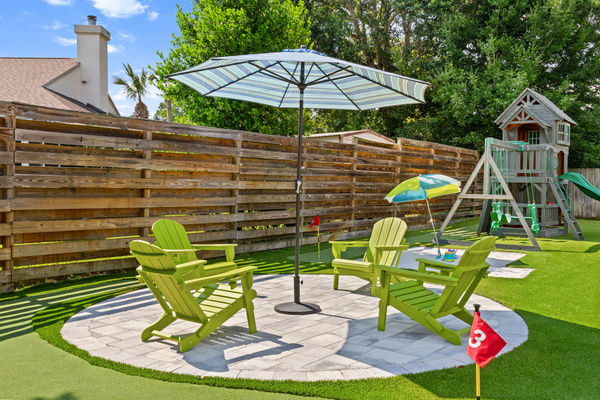 Fun in the sun for everyone! Kick back with a drink in the shade of the large patio umbrella while the kids enjoy the playset or challenge each other to a game on the backyard putting green.