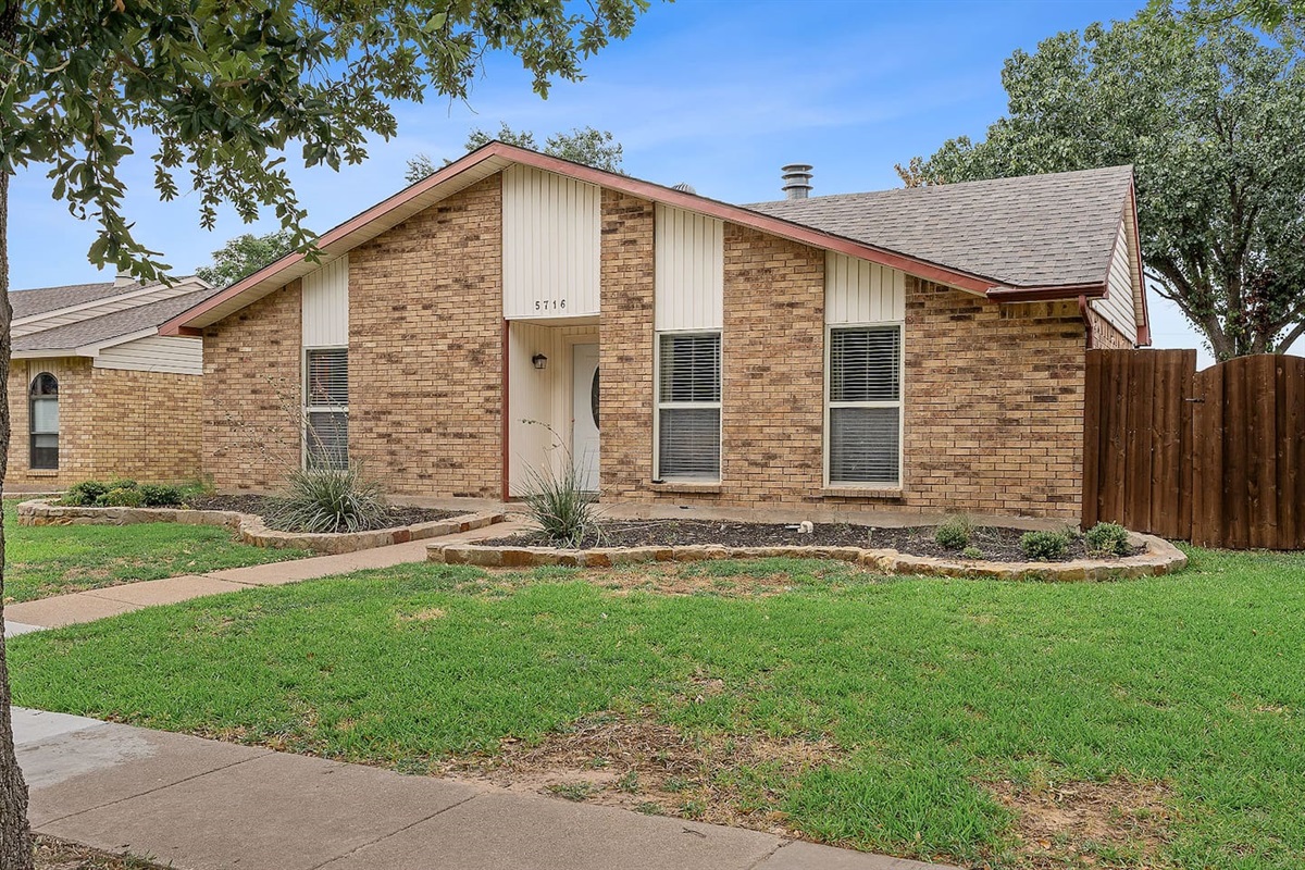 Discover this charming brick home with a beautifully landscaped front yard and welcoming walkway.
