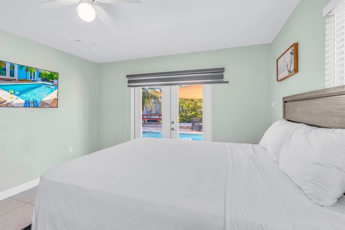 Like the third bedroom, the fourth bedroom also has french doors opening out to the backyard oasis.