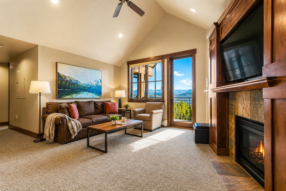 Bright living room with private balcony & fireplace