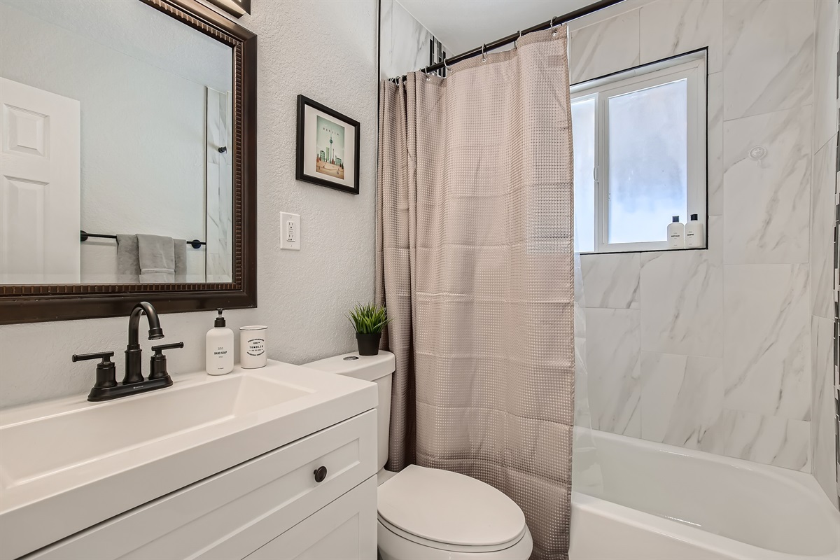 Slightly warmer look of upper bathroom with tub.