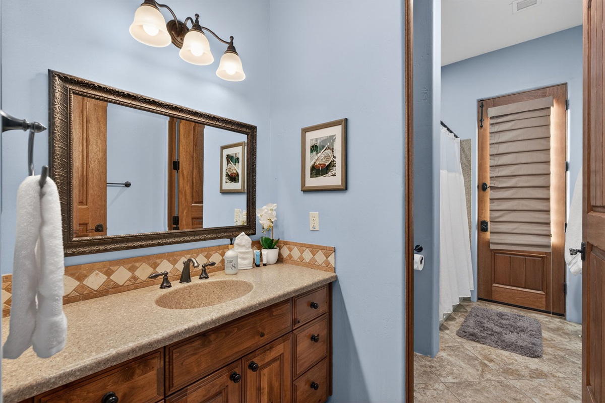 Convenient full bathroom on the first floor with spacious vanity and shower for added guest flexibility