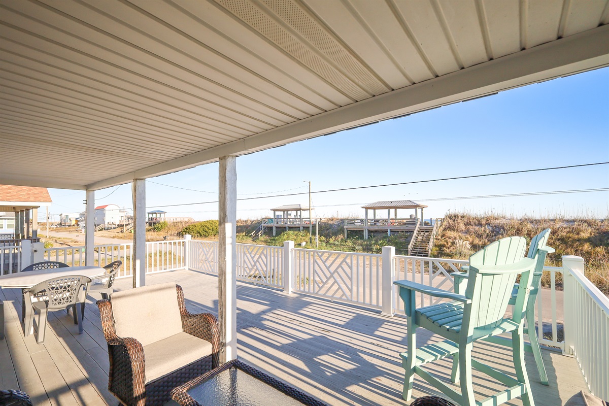 Spacious covered deck just steps from the sand