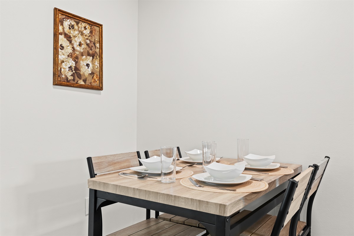 Cozy dining nook set for four—perfect for meals or game night in.