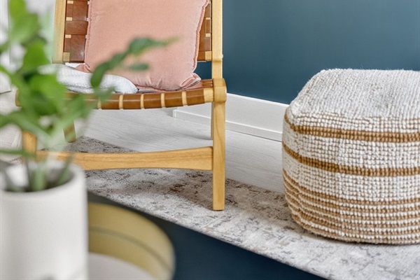 Mid-century details meet modern comfort—accented by warm woods, soft textures, and pops of blush.