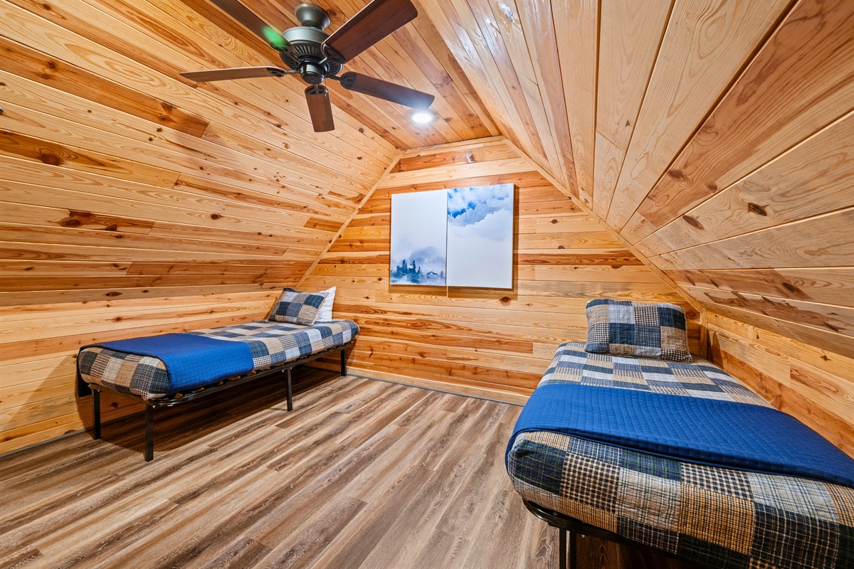 Located upstairs, this open sleeping area offers a fun and comfortable option for kids, teens, or extra guests.