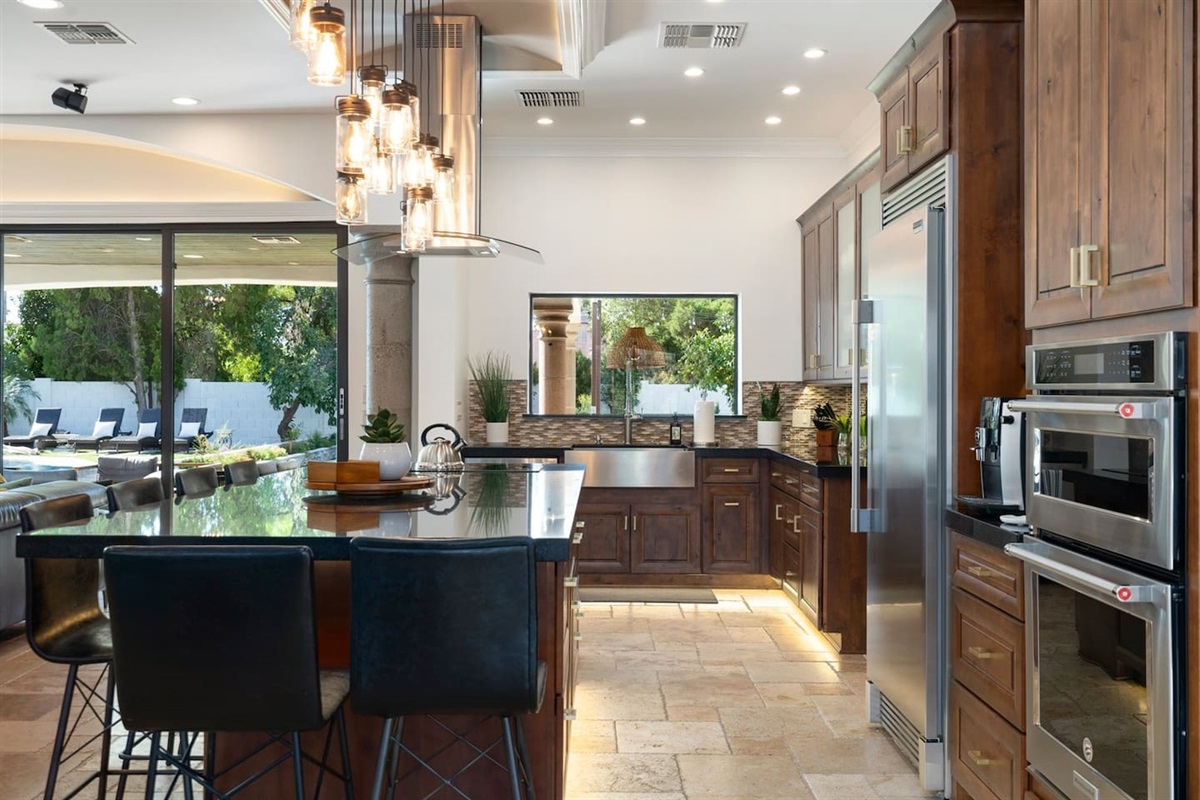 Elevate your dining experience! This stylish kitchen and dining area boast chic ceiling lights and a large fridge for all your culinary creations. Gather, feast, and enjoy!