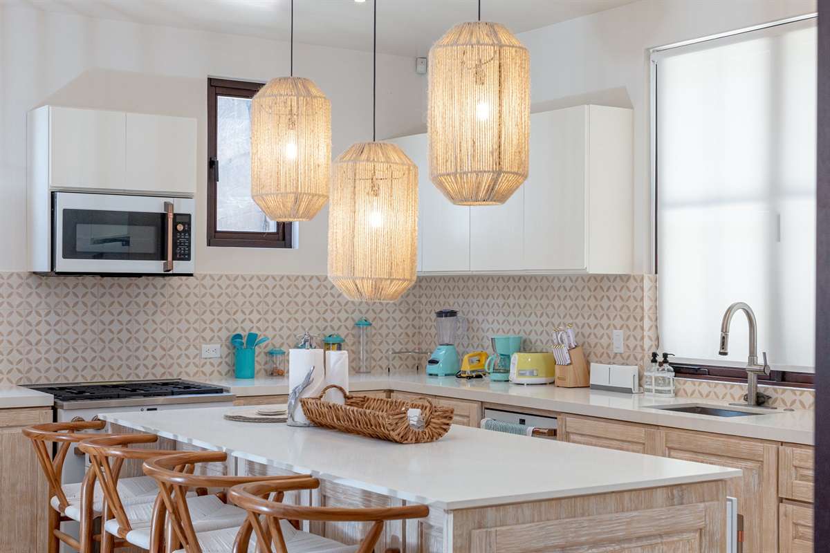 Located in the right wing of the home, the fully equipped kitchen has a gas stove and large island perfect for gathering.
