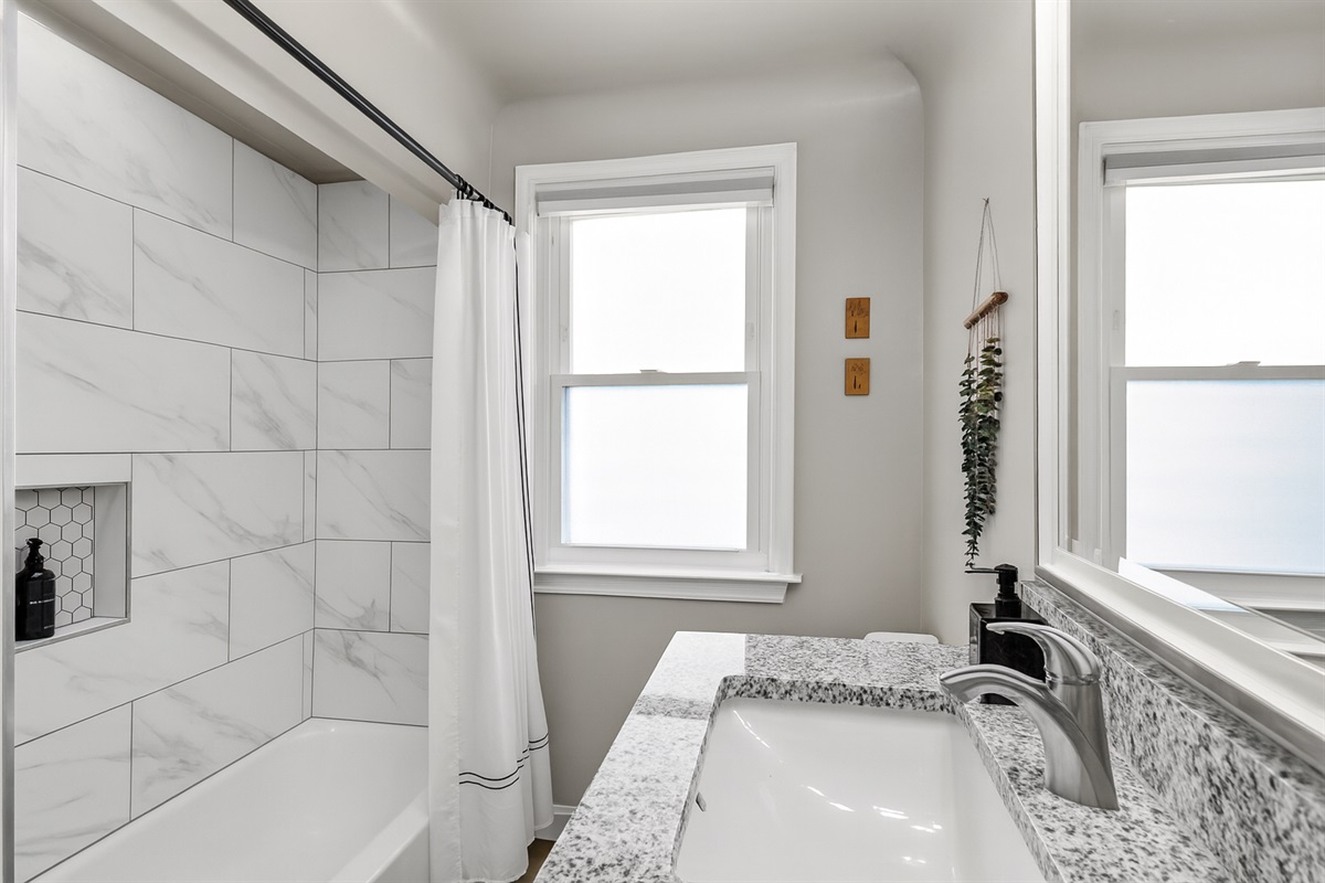 Bathroom features spacious bathtub and luxurious finishes