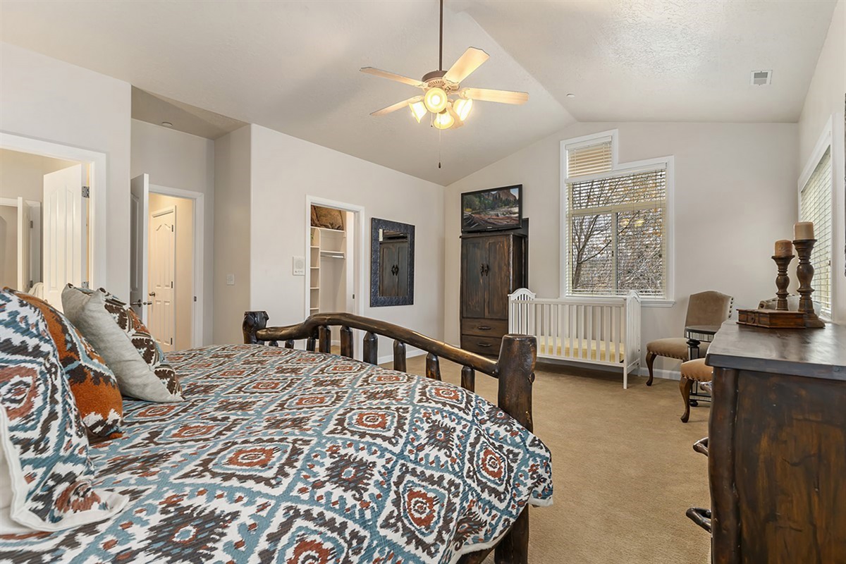 Another view of the spacious primary suite highlights its open layout, warm finishes, and inviting atmosphere.