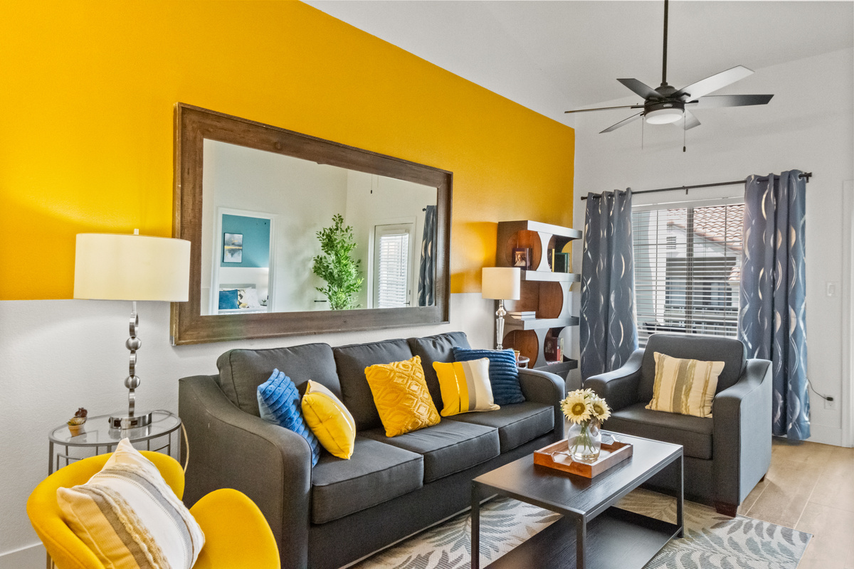 a cozy, living room designed for comfort and calm. With soft seating, and literary touches, it creates the perfect space to relax, read, or unwind.