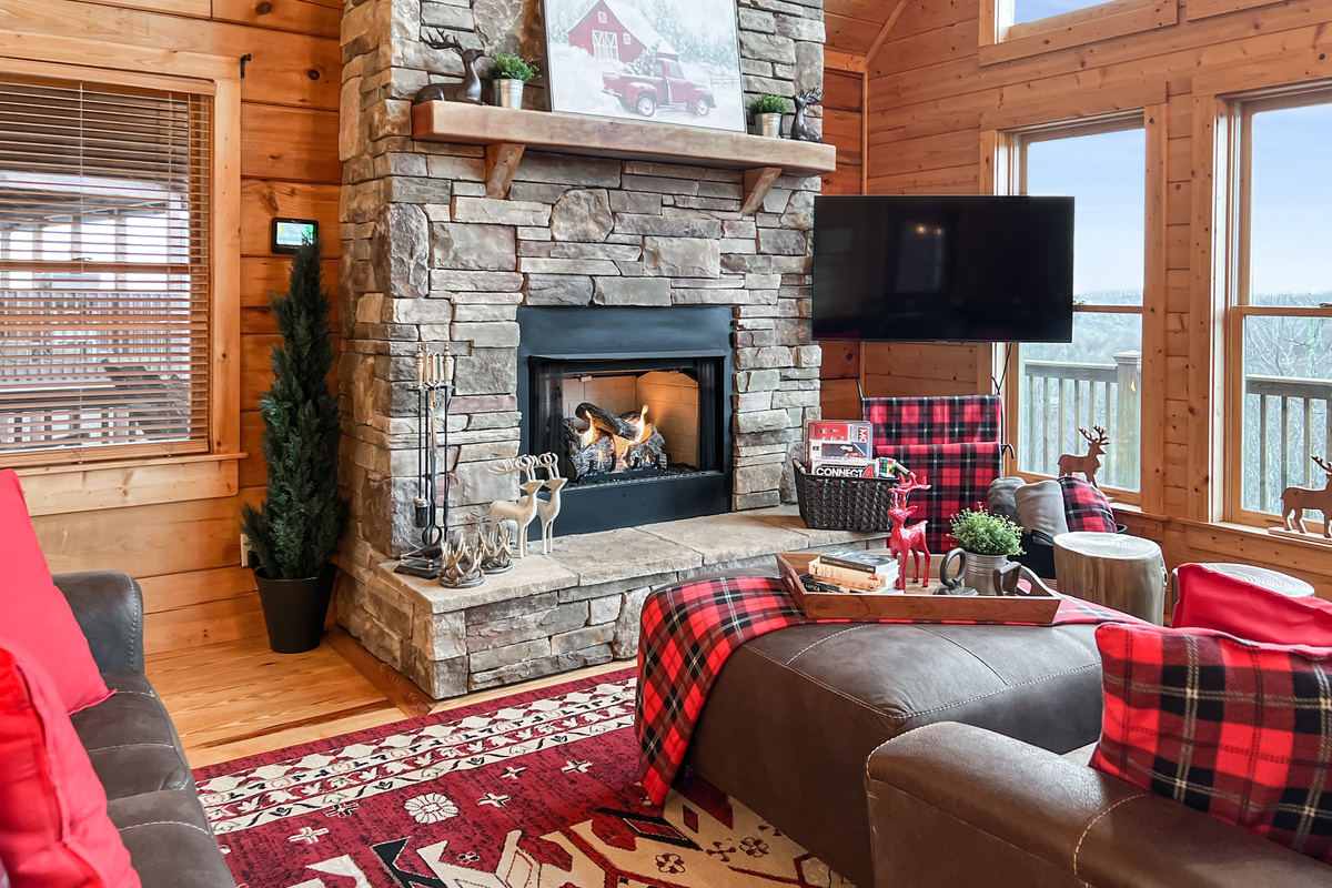 Cozy living-room seating surrounds the stone gas fireplace, creating a comfortable gathering place for the whole group.