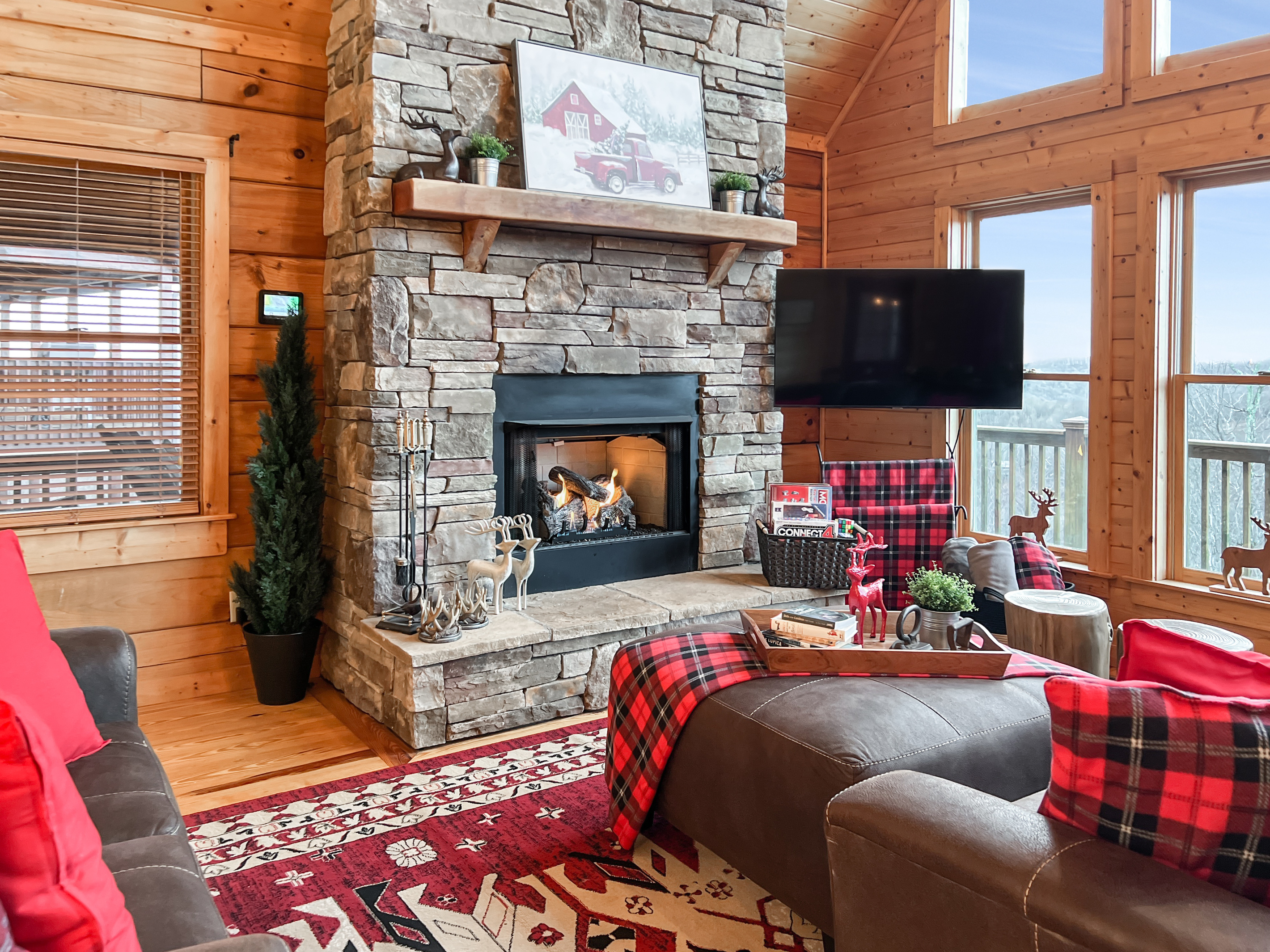 Cozy living-room seating surrounds the stone gas fireplace, creating a comfortable gathering place for the whole group.