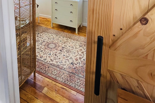 View inside the bedroom from the kitchen. There is a sliding barn door. 