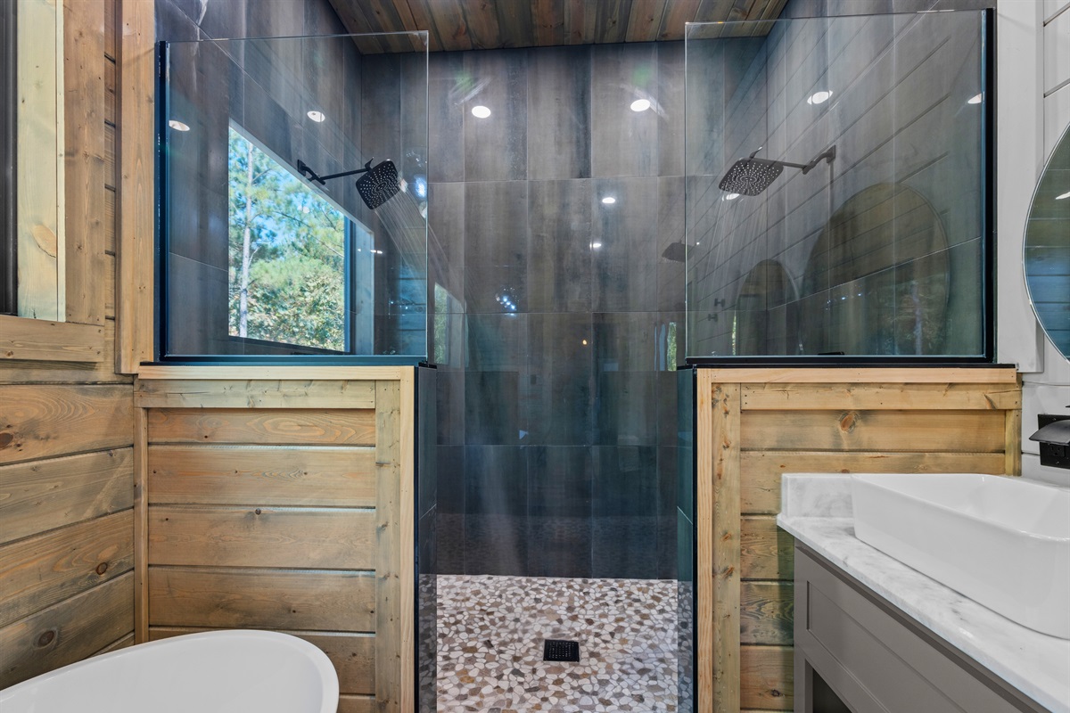 Modern fixtures and a sleek, glass-enclosed shower bring a touch of sophistication to this cozy mountain escape.