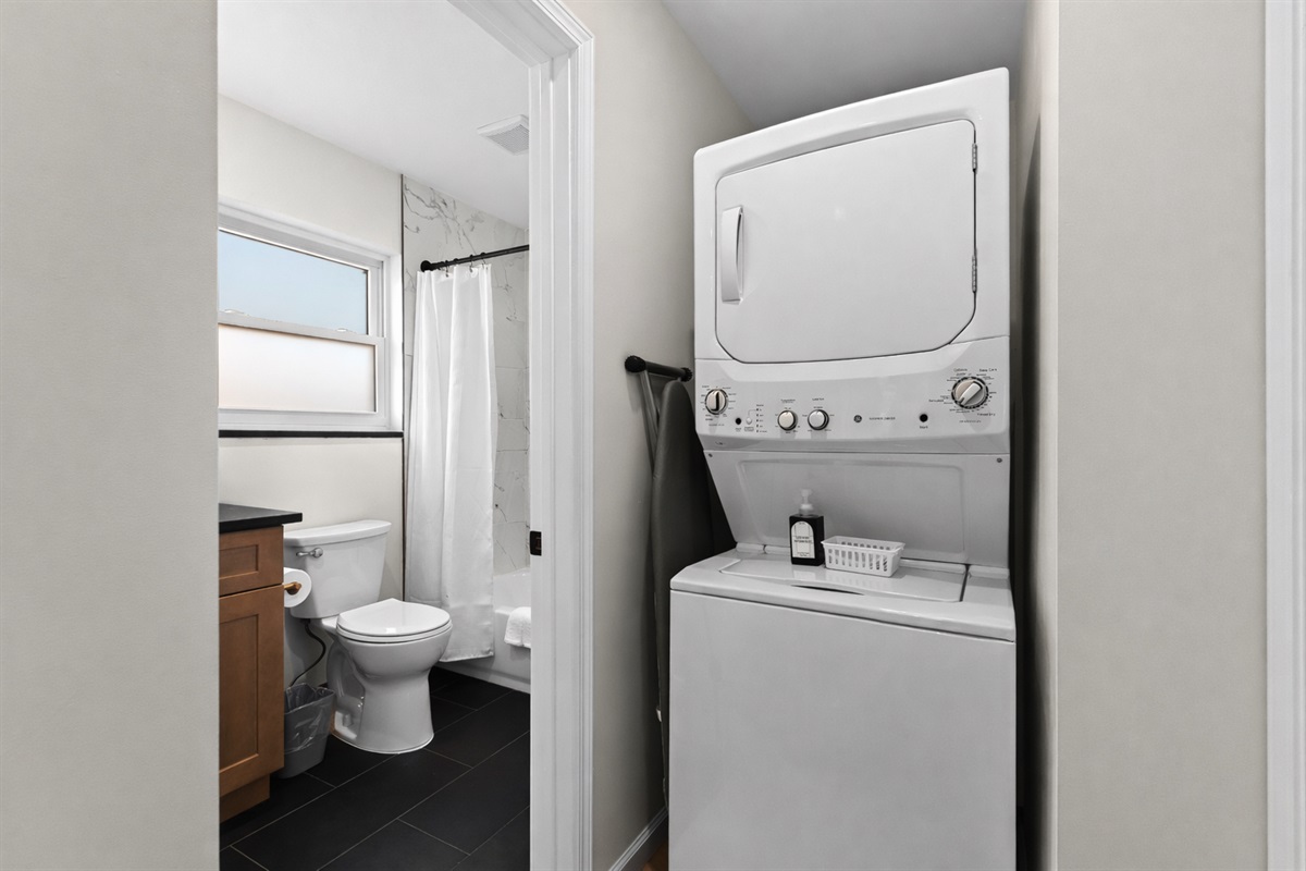 Convenient in-unit laundry tucked beside the bathroom—making longer stays easy, comfortable, and stress-free.