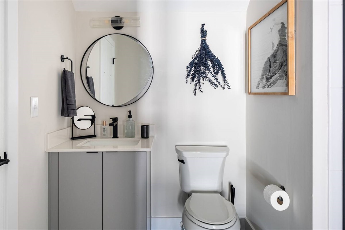The top floor full bathroom sits off a king-sized bedroom with easy access to the rooftop deck. Walk-in shower, complimentary amenities, and closet for clothing storage.