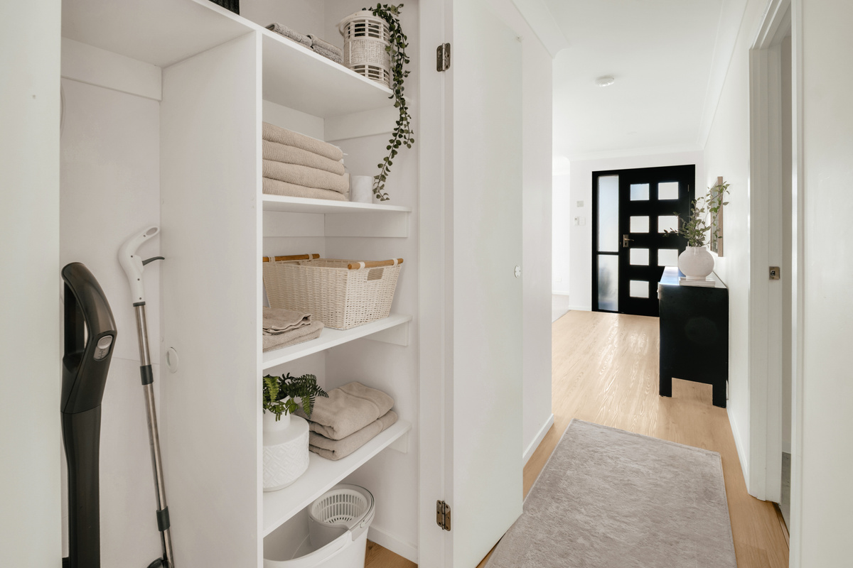 A thoughtfully organised storage cupboard with fresh towels, cleaning essentials and handy supplies for your stay.