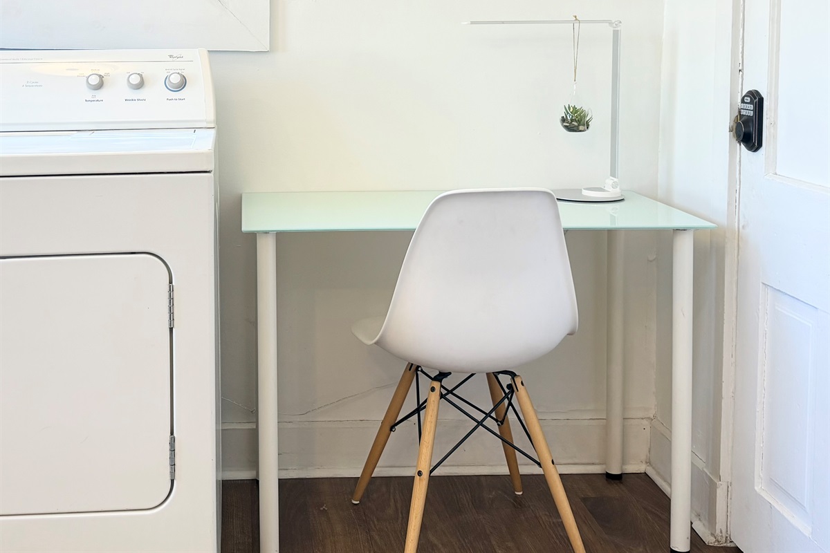 A thoughtfully designed workspace in the kitchen — the sunniest room of the home — with garden views and easy outdoor access for fresh-air breaks between calls.