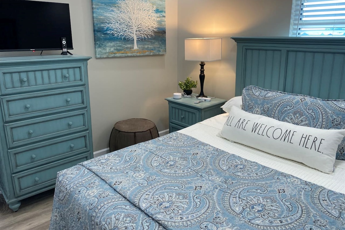 Welcome to the queen bedroom which includes a 32 inch Roku smart TV.