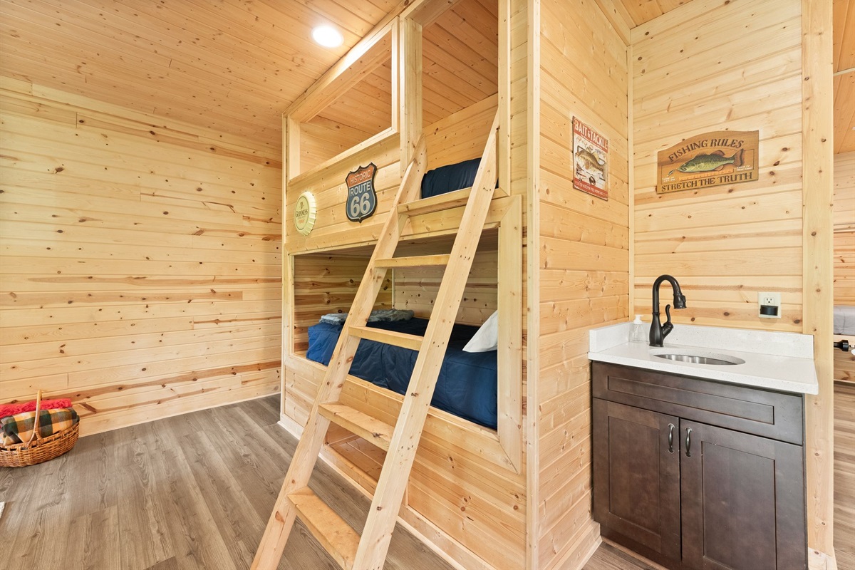 Lower-level open sleeping area with twin bunk beds, perfect for kids, friends, and fun cabin sleepovers.