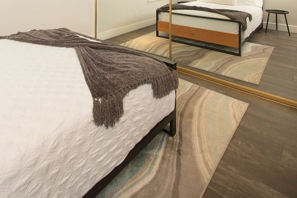 2nd bedroom with queen bed and full body length mirror