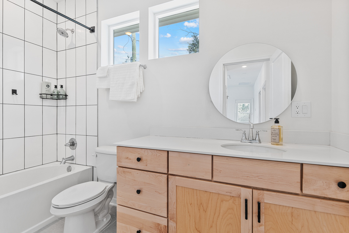 A full tub for bath time and a shower for everyone else. Warm maple, crisp white tile and sunlight from above keep the morning rush painless, so you can all get out the door and into the day together.