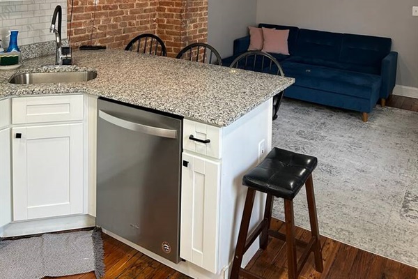 Large TV and entertainment area mounted on the exposed brick wall