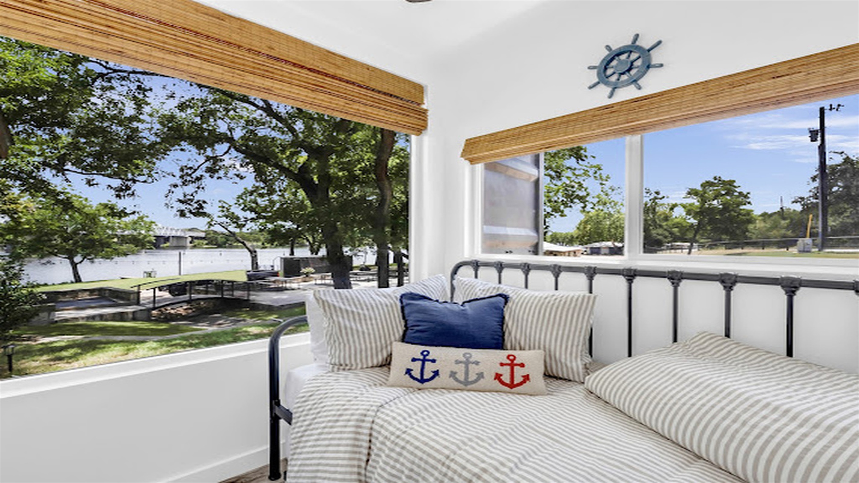 Cozy daybed with tranquil river and tree-lined views.