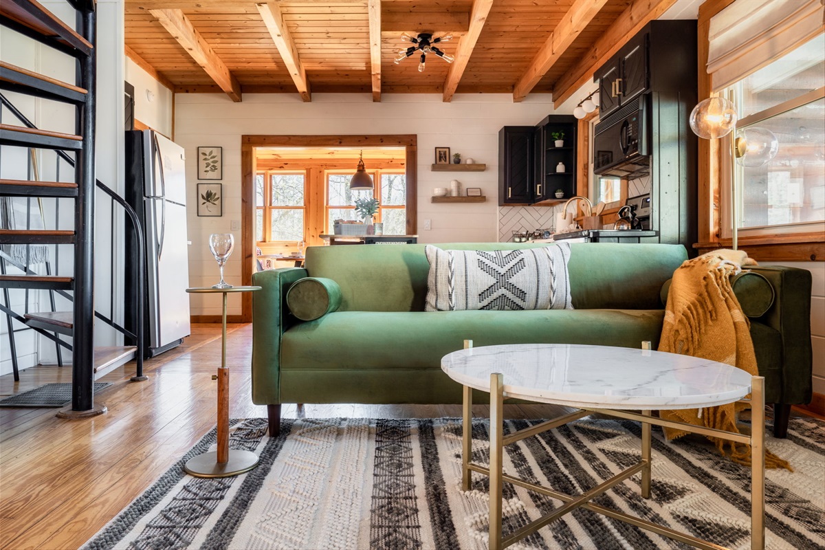 Open, airy and cozy living room with spiral staircase to access the upper level.