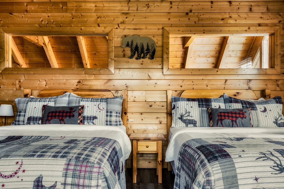 The second upstairs bedroom features 2 queen beds and an ensuite bathroom