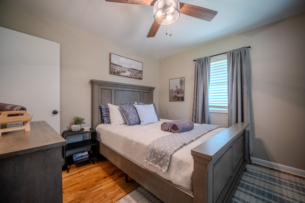 This welcoming bedroom offers a cozy queen bed, plush pillows, and plenty of comfort after a long day. 