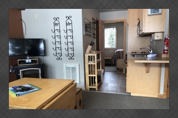 Livingroom area leading to kitchen, bathroom & bedroom.