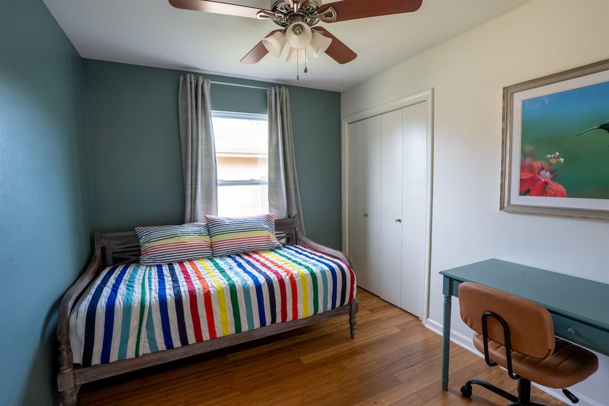 bedroom 3 has 2 single beds, one work space