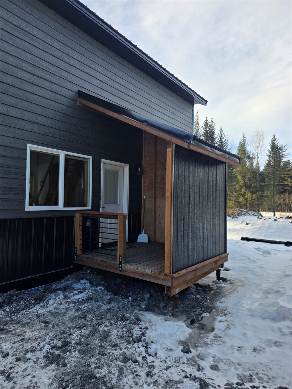 Cabin entrance with covered porch area.  There will be steps added to the porch and a freezer on the porch.