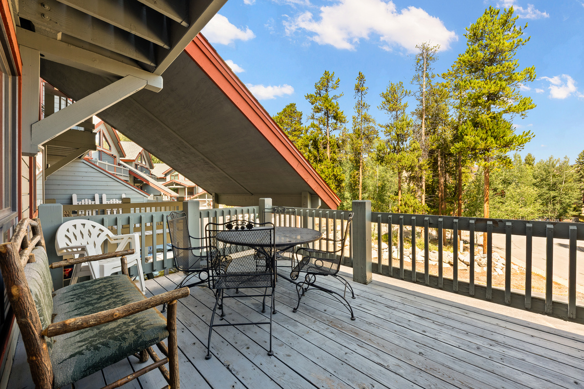 Spacious main level balcony with dining table and seating. Partially covered. This is one of four outdoor living spaces. 