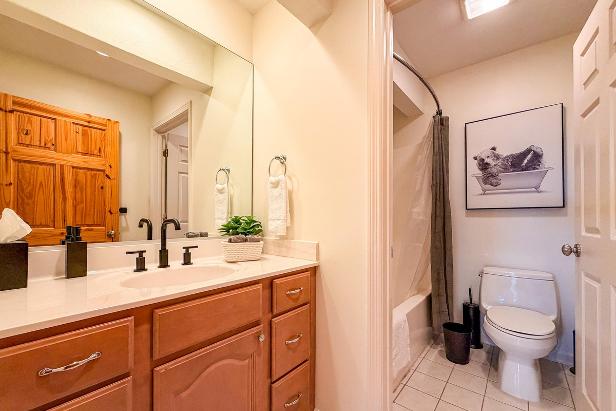 This upstairs bathroom is conveniently located between the guest bedroom and the bunk room. It is a full bathroom featuring a tub/shower combination.