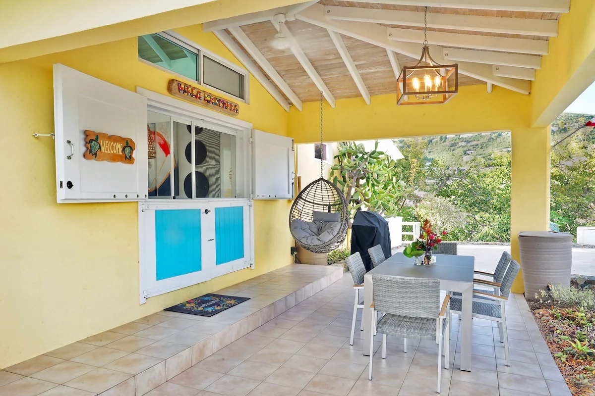 Front entrance of Villa Marbella also has covered outdoor space with dining table.