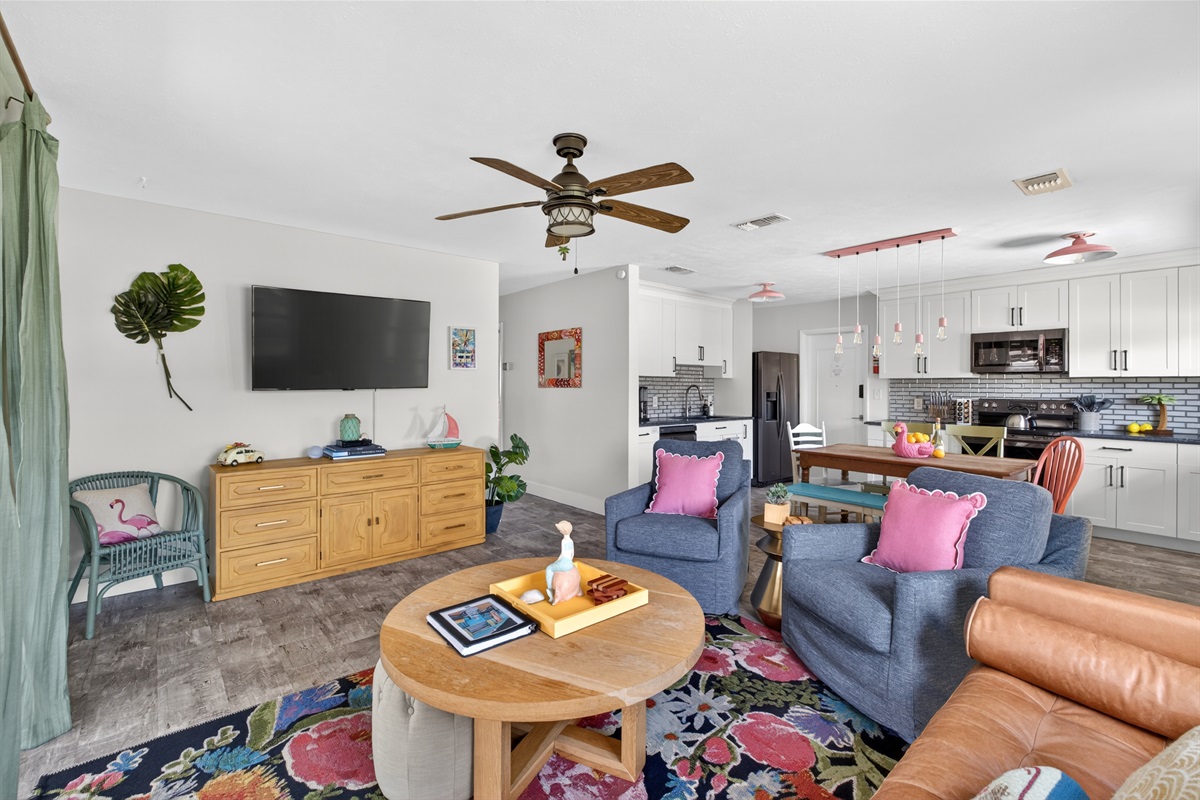 Open living, kitchen and dining area with comfortable seating.
