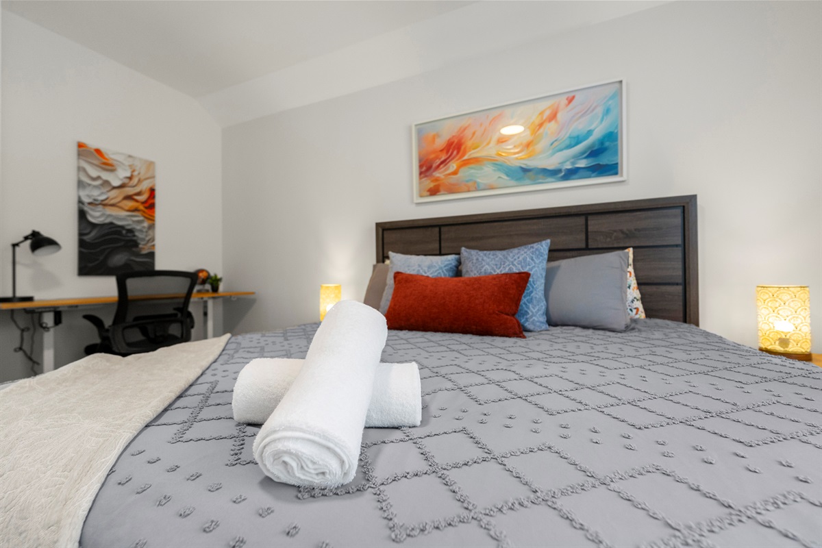 A warm and welcoming bedroom with soft lighting and a relaxing atmosphere.