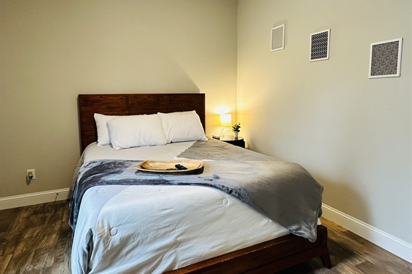 Queen Bed with comforter, an extra blanket, and four hypoallergenic pillows.