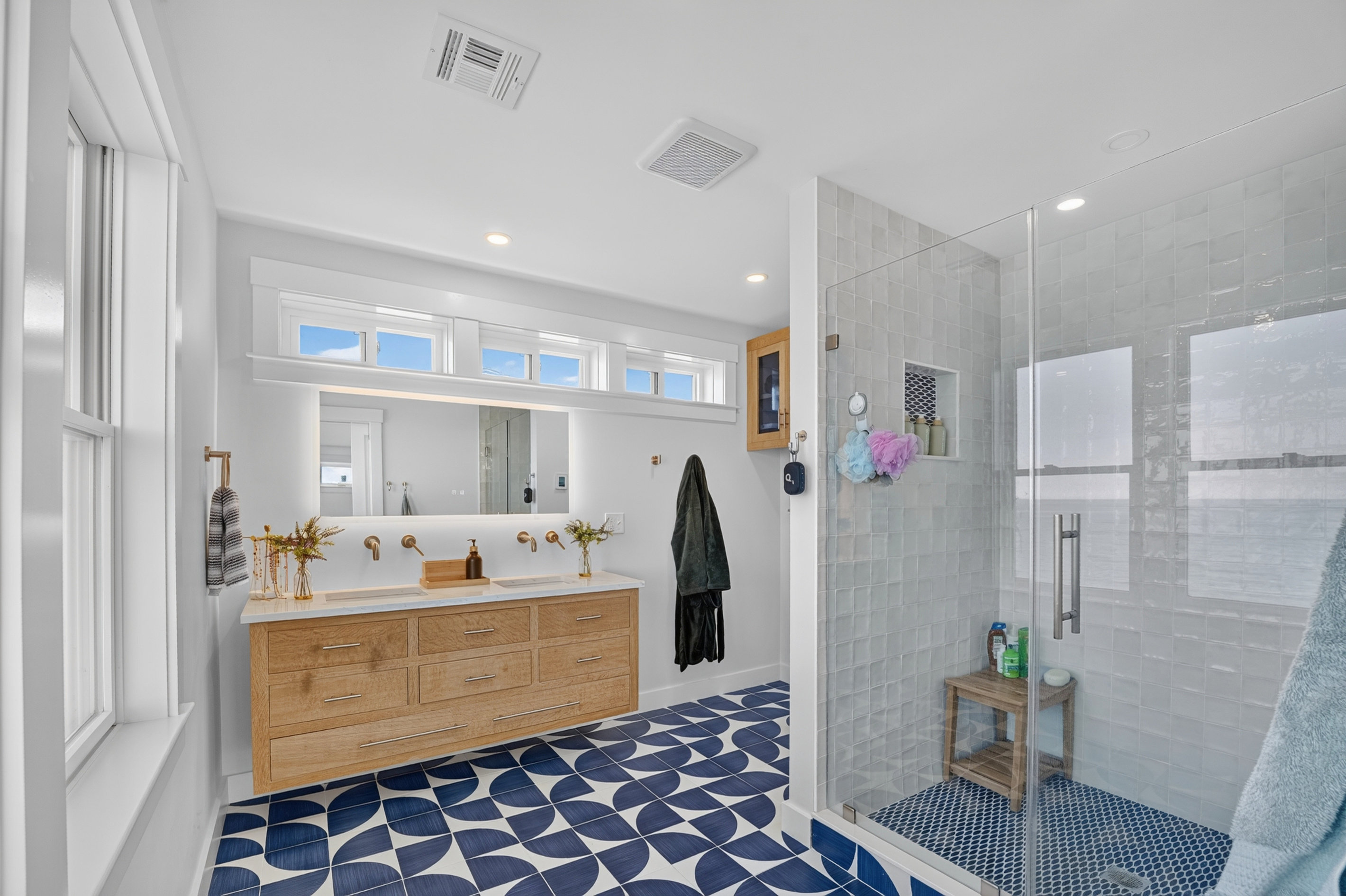 A spacious bathroom featuring modern finishes and plenty of room to get ready.