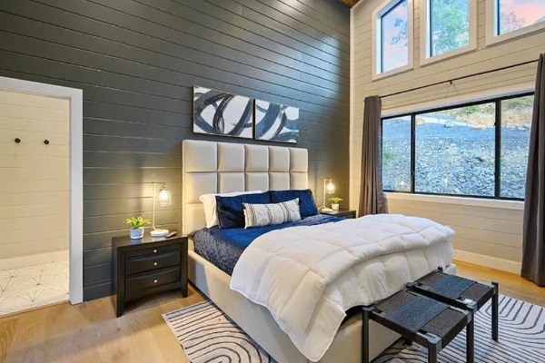 Comfortable bedroom with modern décor and ample natural light.