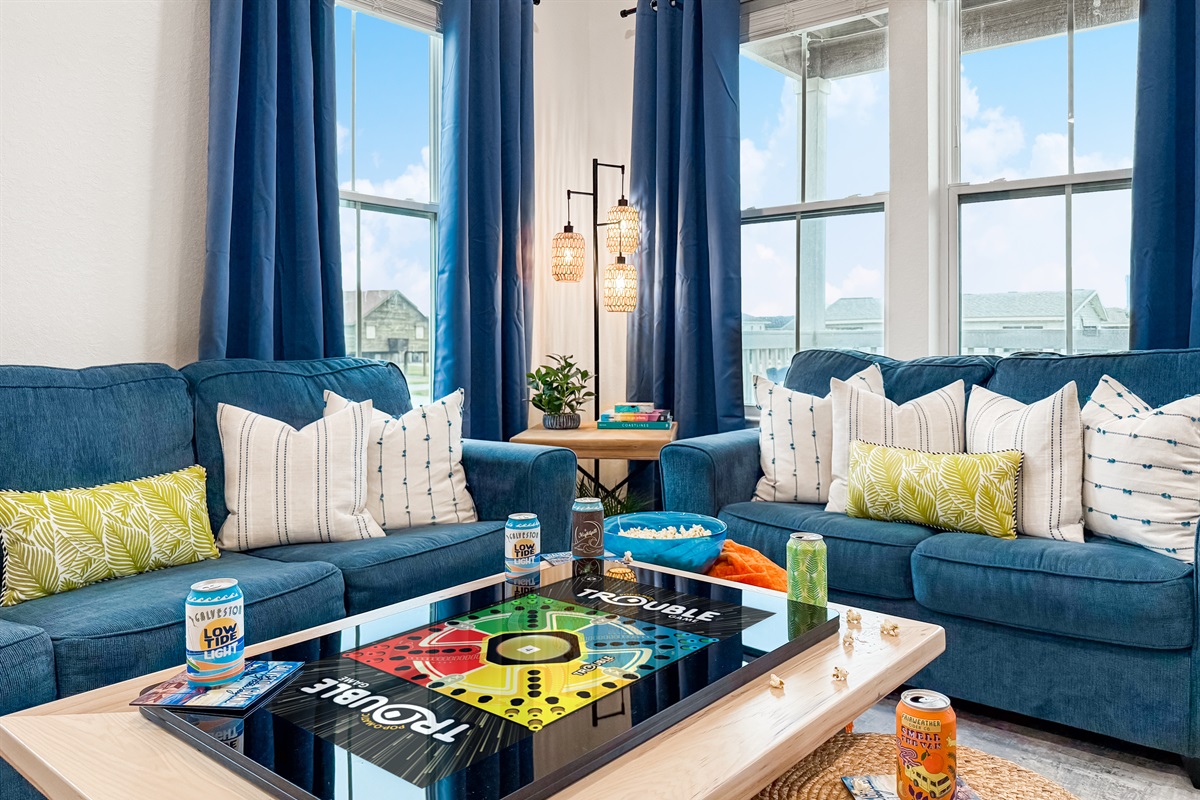 Walk into the bright living room and take in the beachy vibes!